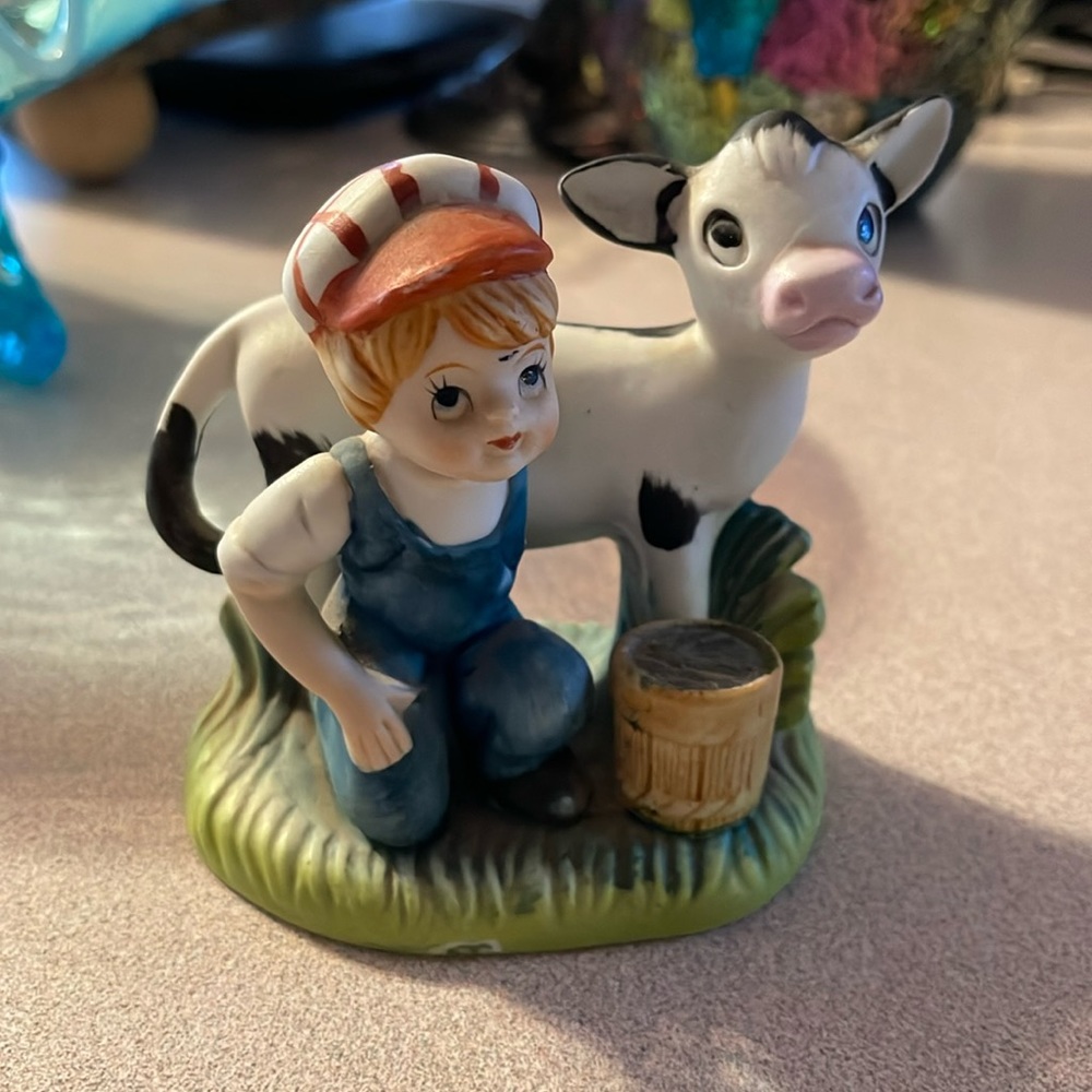 Little boy with cow figurine